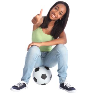 High school age African-American girl sitting on a soccer ball with thumbs up
