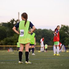 High school age female soccer players on field