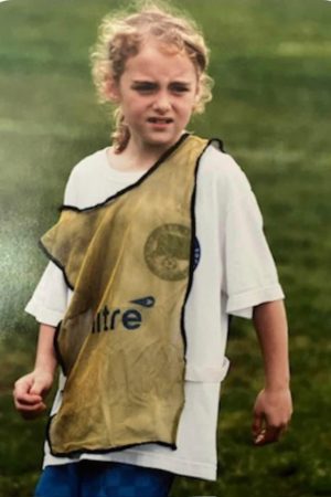 Young Maggie Pierce with a serious during practice on the field