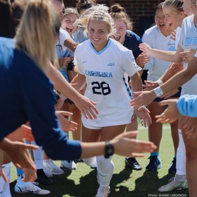 Maggie Pierce, #28 in UNC soccer uniform with teammates